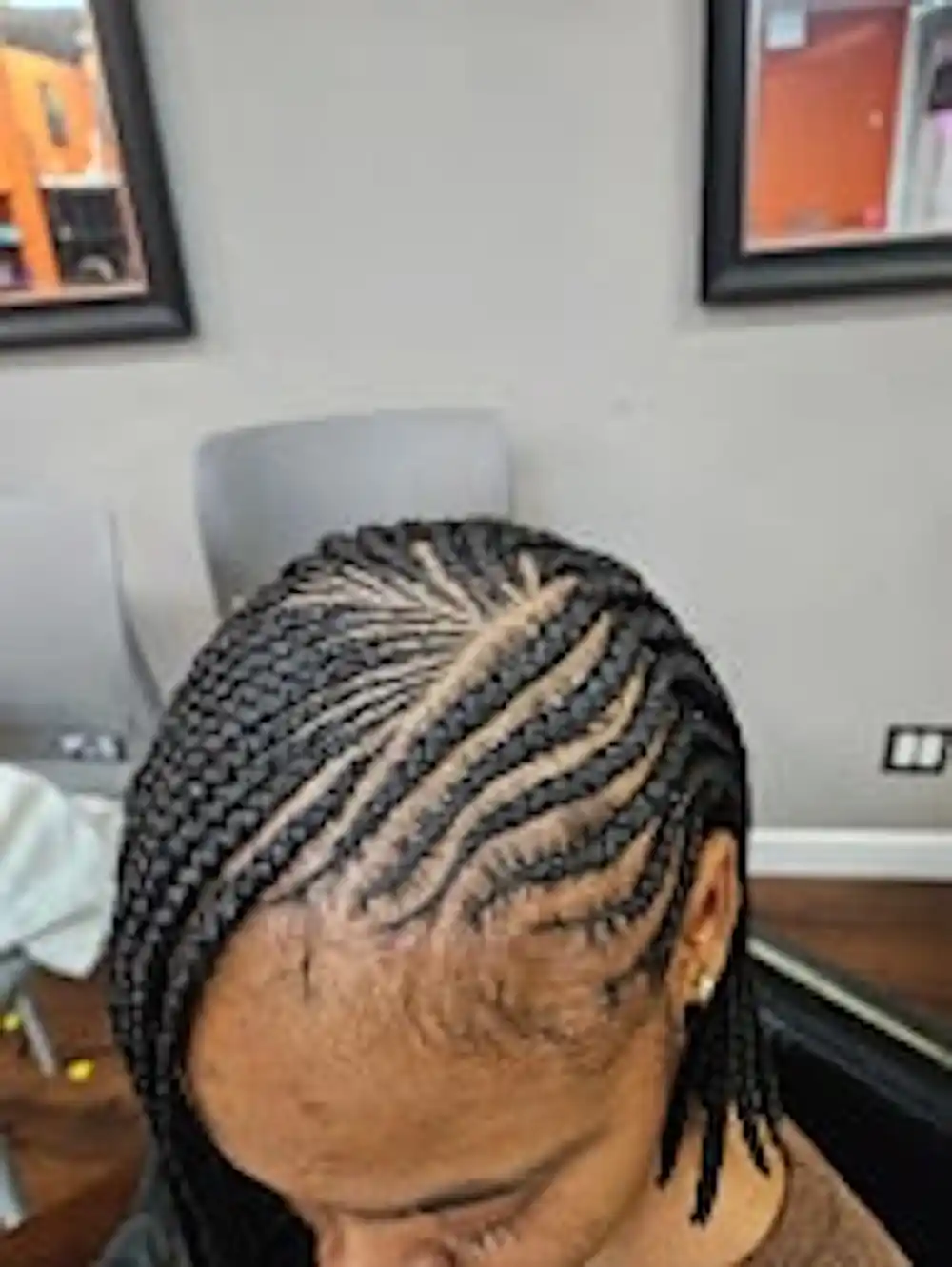 Close-up of neat side braids on relaxed hair at Ramas Hair Braiding salon