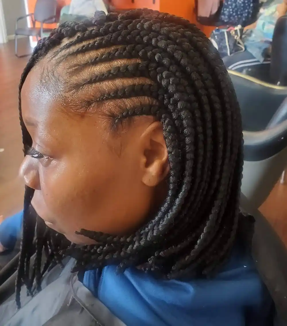 Client with long side braids styled at Ramas Hair Braiding in Indianapolis